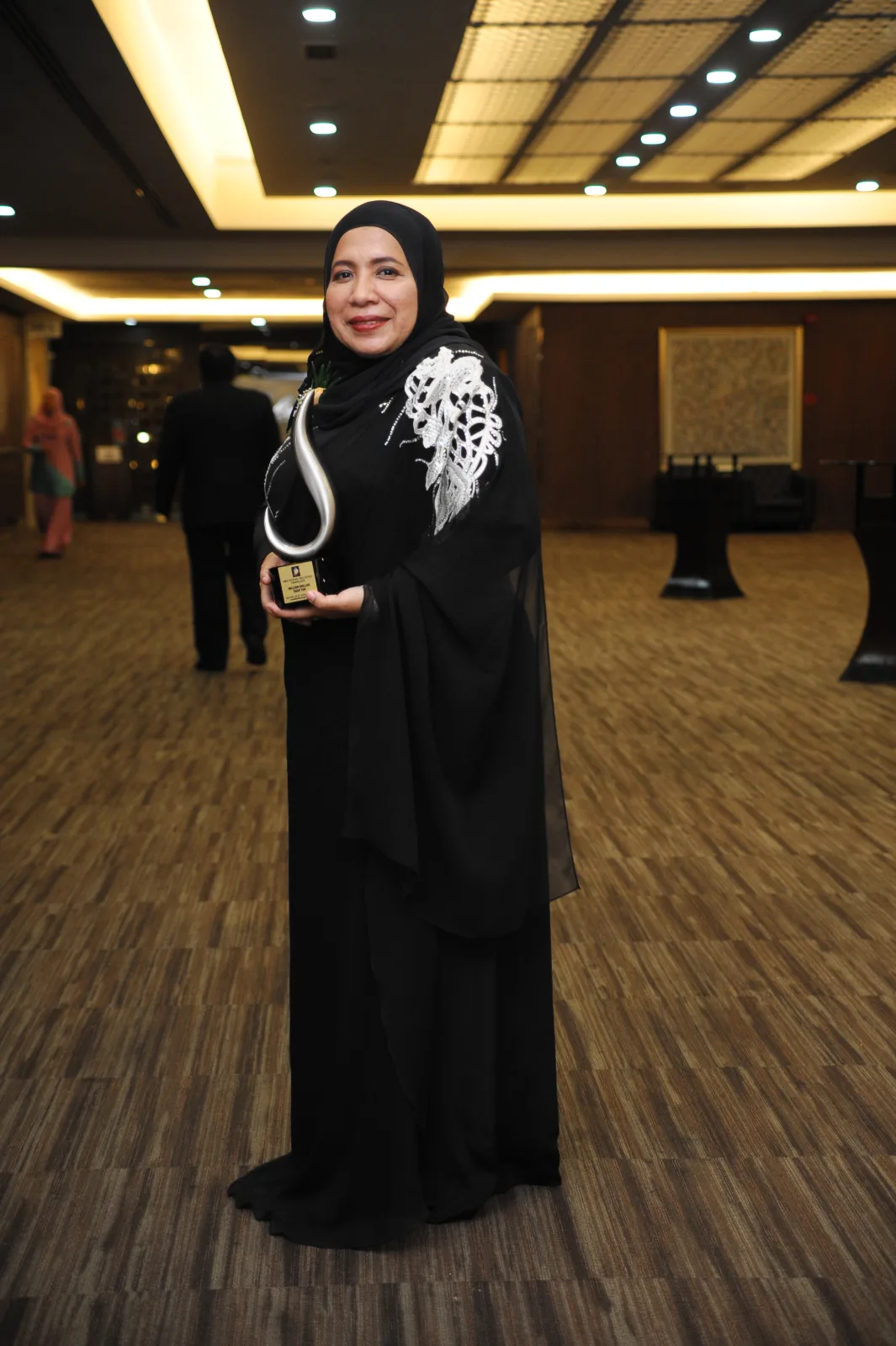 Munirah Mohammad holding her 2016 award