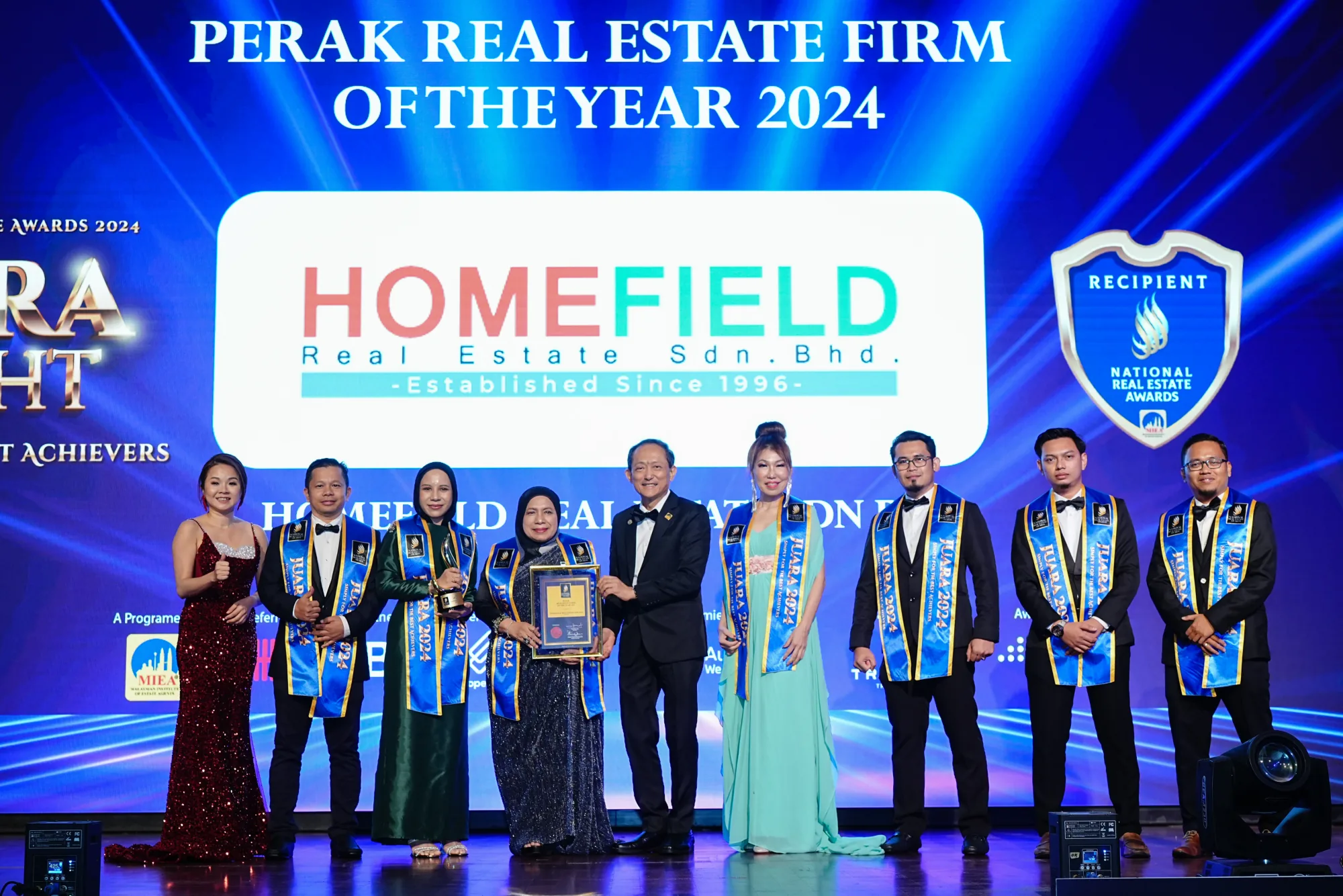 Homefield Real Estate team on stage after receiving the 2024 Perak Real Estate Firm of the Year award