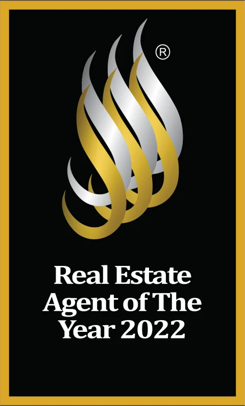 NREA Real Estate Agent of The Year 2022 badge, gold flame on black